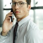 Man in White Dress Shirt Holding Smartphone